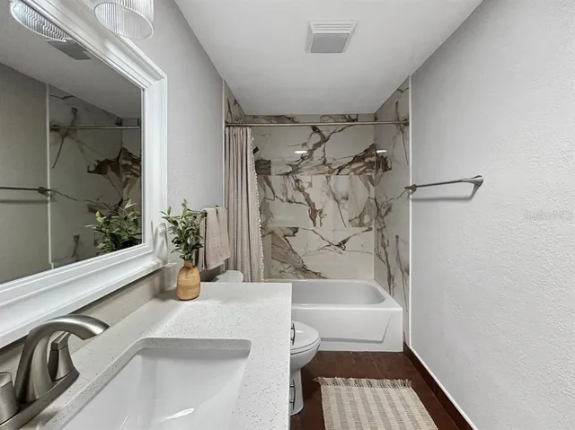 a bathroom with a bathtub and shower