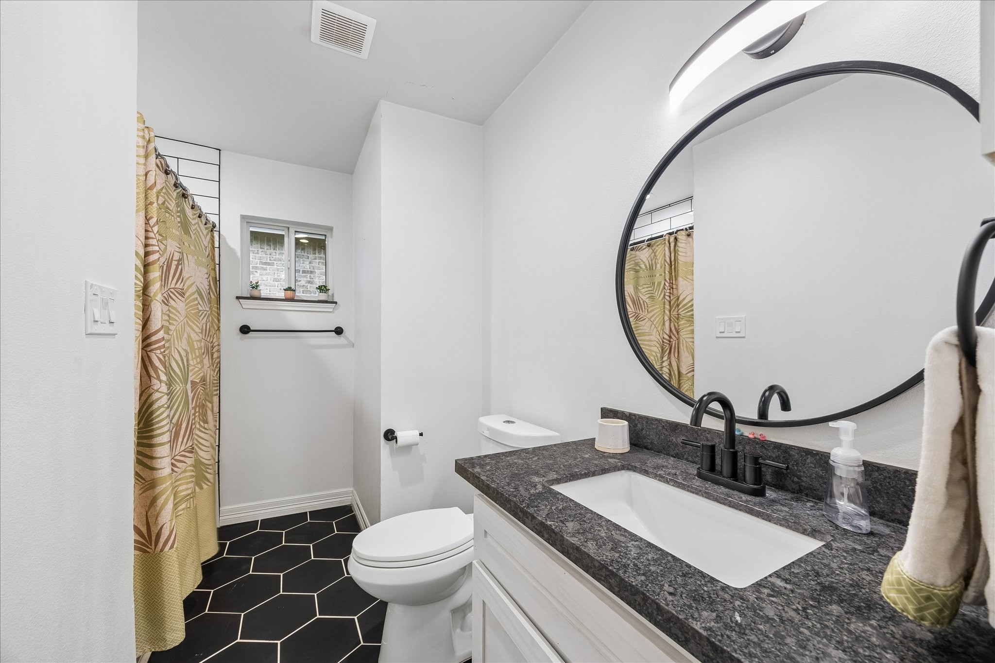 5526 Grape Street Houston, TX 77096 - Photo 10 of 10 a bathroom with a granite countertop sink mirror vanity and toilet