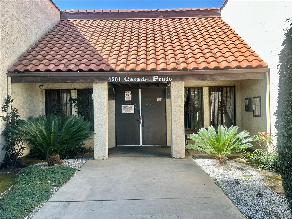 4501 Peck Road, Unit 63 El Monte, CA 91732 - Photo 1 of 21 front view of a brick house with a large window and potted plants