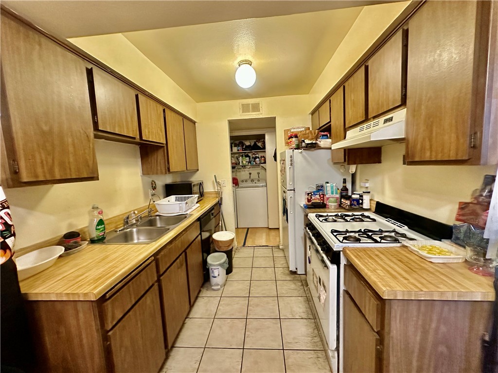 4501 Peck Road, Unit 63 El Monte, CA 91732 - Photo 12 of 21 a kitchen with stainless steel appliances a sink a stove and a refrigerator