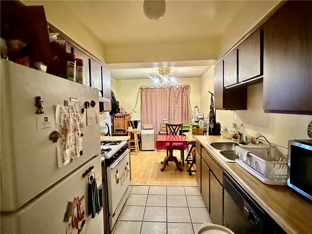 4501 Peck Road, Unit 63 El Monte, CA 91732 - Photo 13 of 21 a kitchen with stainless steel appliances a stove a sink and a refrigerator