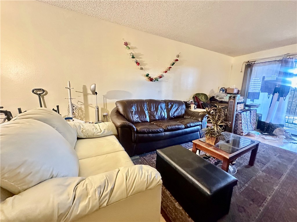 4501 Peck Road, Unit 63 El Monte, CA 91732 - Photo 18 of 21 a living room with furniture a rug and a table