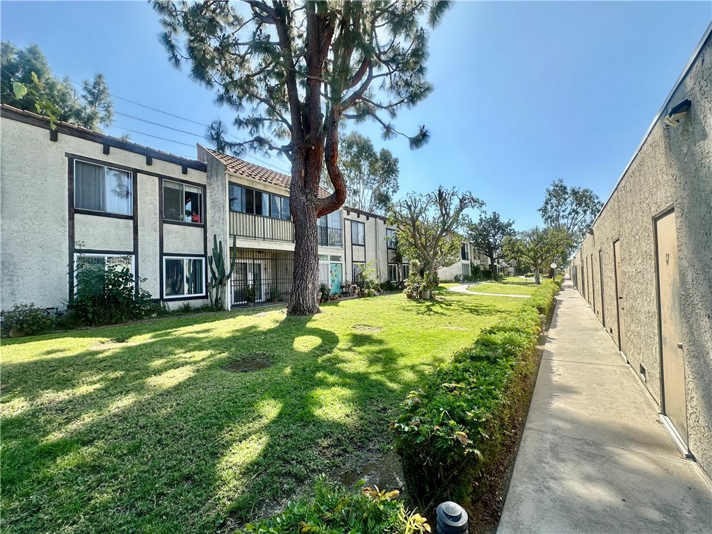 4501 Peck Road, Unit 63 El Monte, CA 91732 - Photo 4 of 21 a view of a house with a large tree and a yard with plants