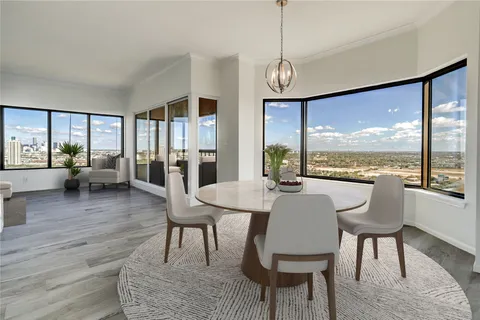 a view of a dining room with furniture window and wooden floor