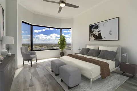 a bedroom with a large bed and a large window