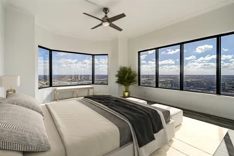 a bedroom with a large bed and a large window