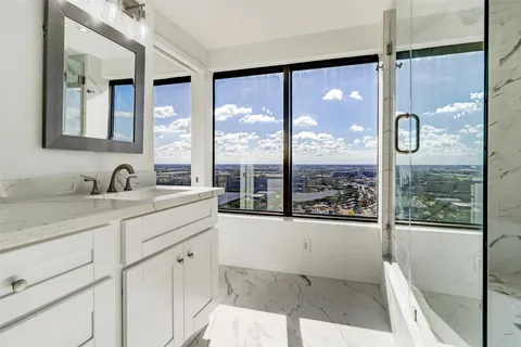 a bathroom with a double vanity sink and a window