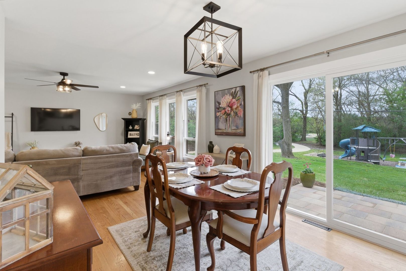11N980 Almora Terrace Elgin, IL 60124 - Photo 7 of 29 a dining room with furniture a flat screen tv and a large window