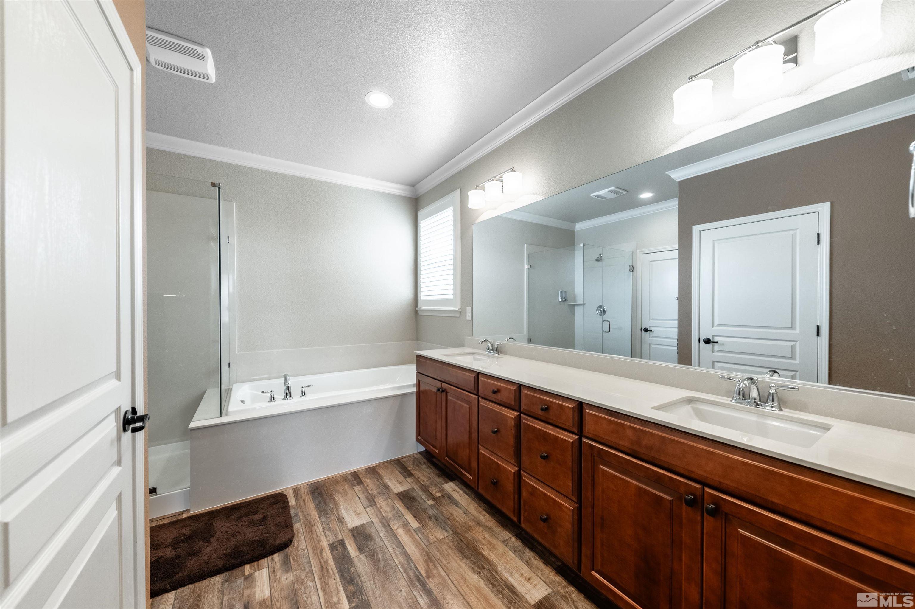 990 Broderick Trail Reno, NV 89523 - Photo 26 of 38 a bathroom with a tub sink double vanity granite tub shower and mirror