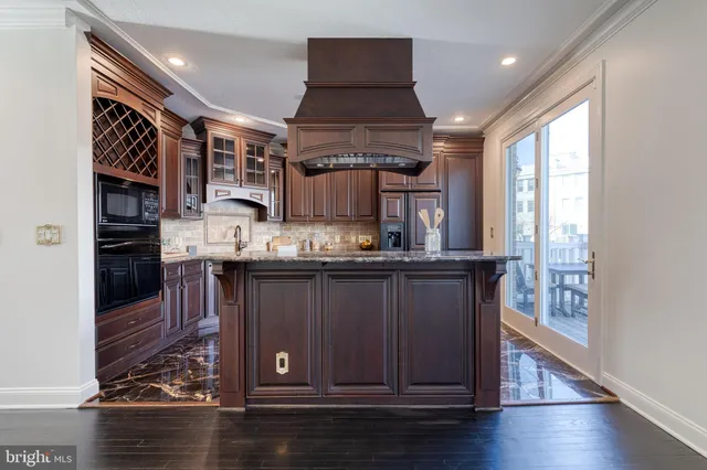 a kitchen with stainless steel appliances granite countertop a stove and cabinets