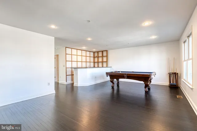 a view of a hallway to a closet and chandelier fan