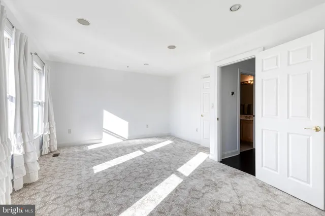 a view of a roof deck with table and chairs with wooden floor