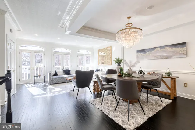 a view of a dining room with furniture wooden floor and chandelier