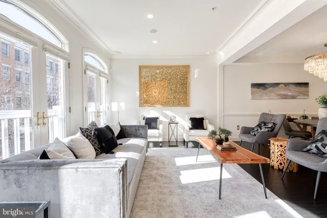 a living room with furniture and large windows