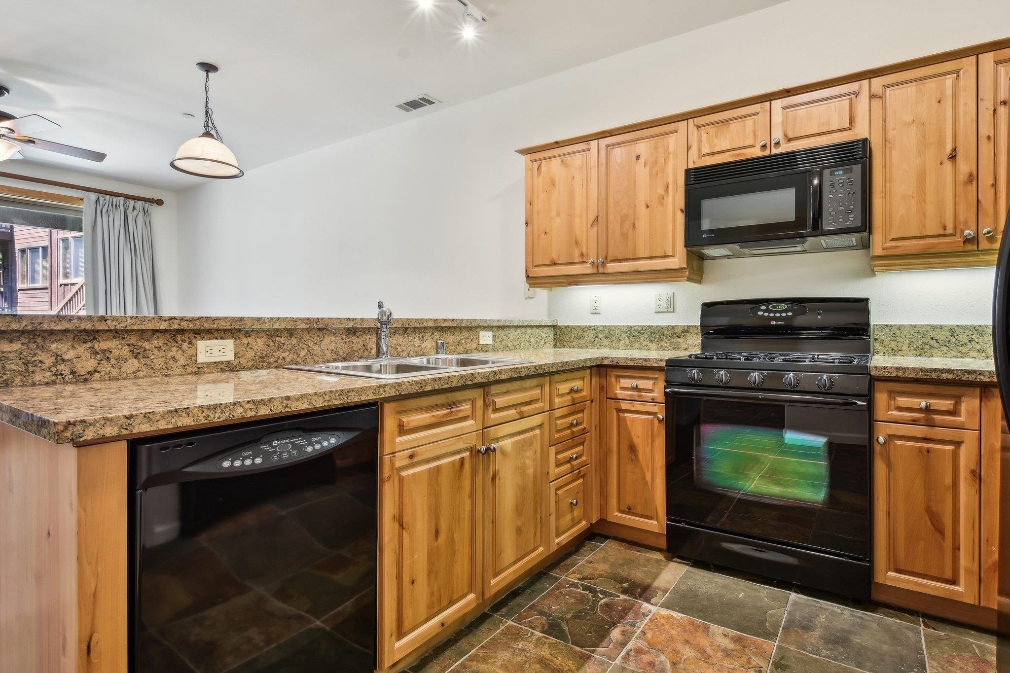10844 Cinnabar Way, Unit 3 Truckee, CA 96161 - Photo 8 of 28 a kitchen with stainless steel appliances granite countertop a stove top oven a sink and dishwasher