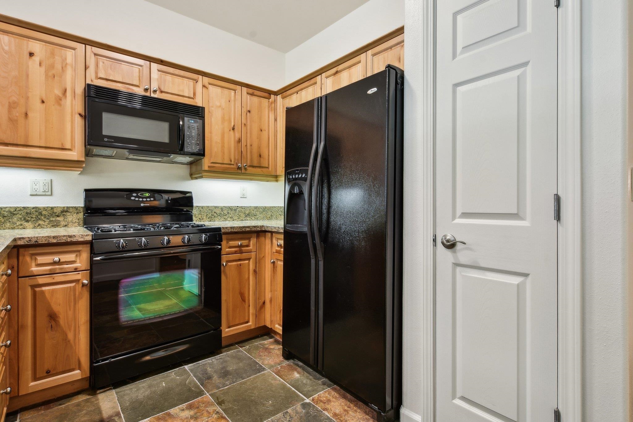 10844 Cinnabar Way, Unit 3 Truckee, CA 96161 - Photo 9 of 28 a kitchen with stainless steel appliances a stove a microwave and a refrigerator