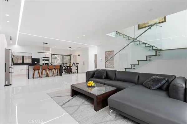 a living room with furniture and kitchen view