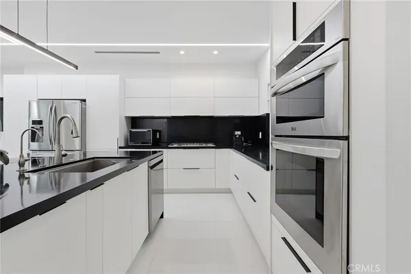 a kitchen with stainless steel appliances a sink and cabinets