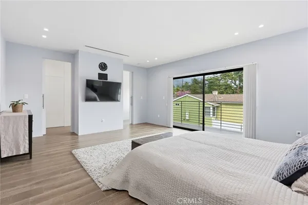 a bedroom with a large bed and a large window
