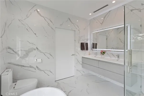 a spacious bathroom with a bathtub and sink