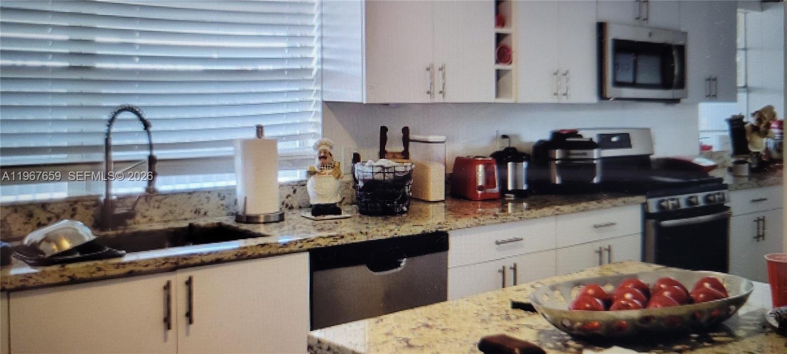 998 East 29th Street Hialeah, FL 33013 - Photo 3 of 3 a kitchen with a sink and cabinets