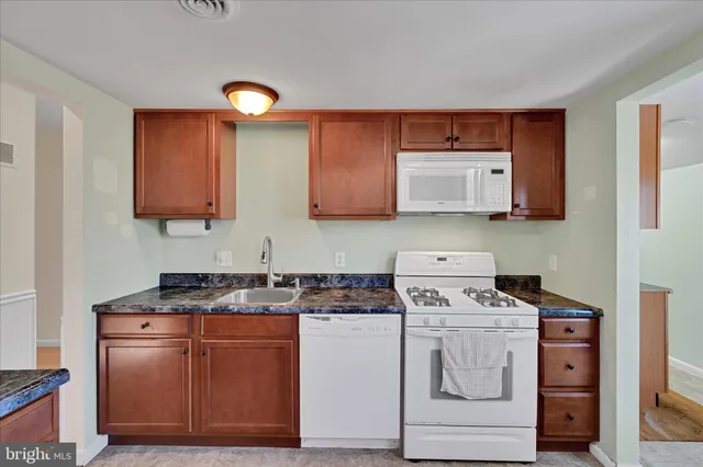 a kitchen with appliances a sink and a stove