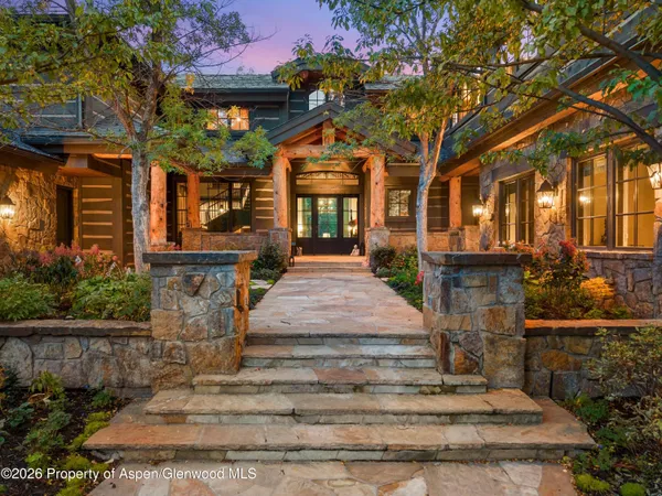 a kitchen with kitchen island granite countertop a sink a counter top space and stainless steel appliances