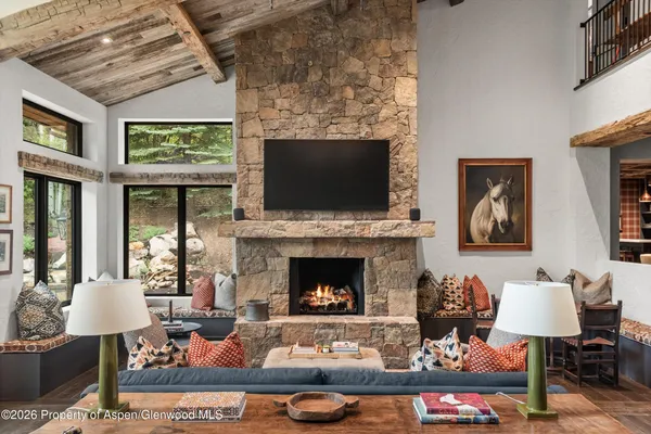 a living room with furniture tv and a fireplace