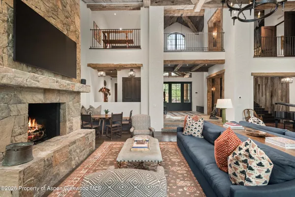 a room with stainless steel appliances kitchen island granite countertop furniture and a fireplace