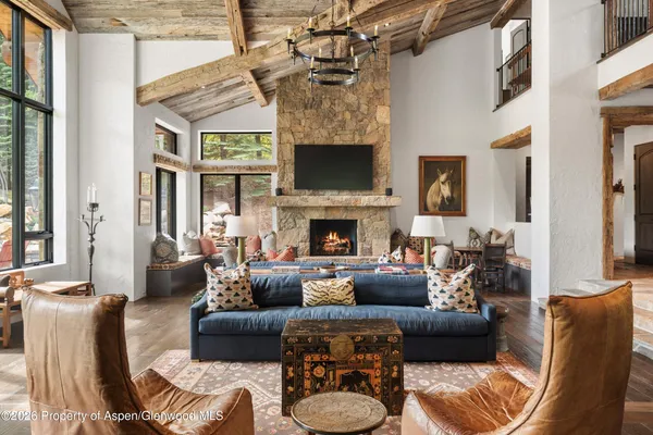 a bedroom with a bed chair and a large window