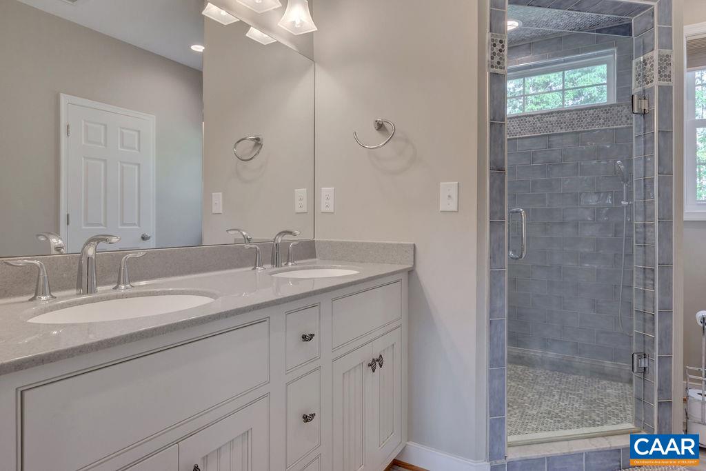 1275 Poplar Spring Road Scottsville, VA 24590 - Photo 17 of 51 a bathroom with a granite countertop sink a mirror and a shower