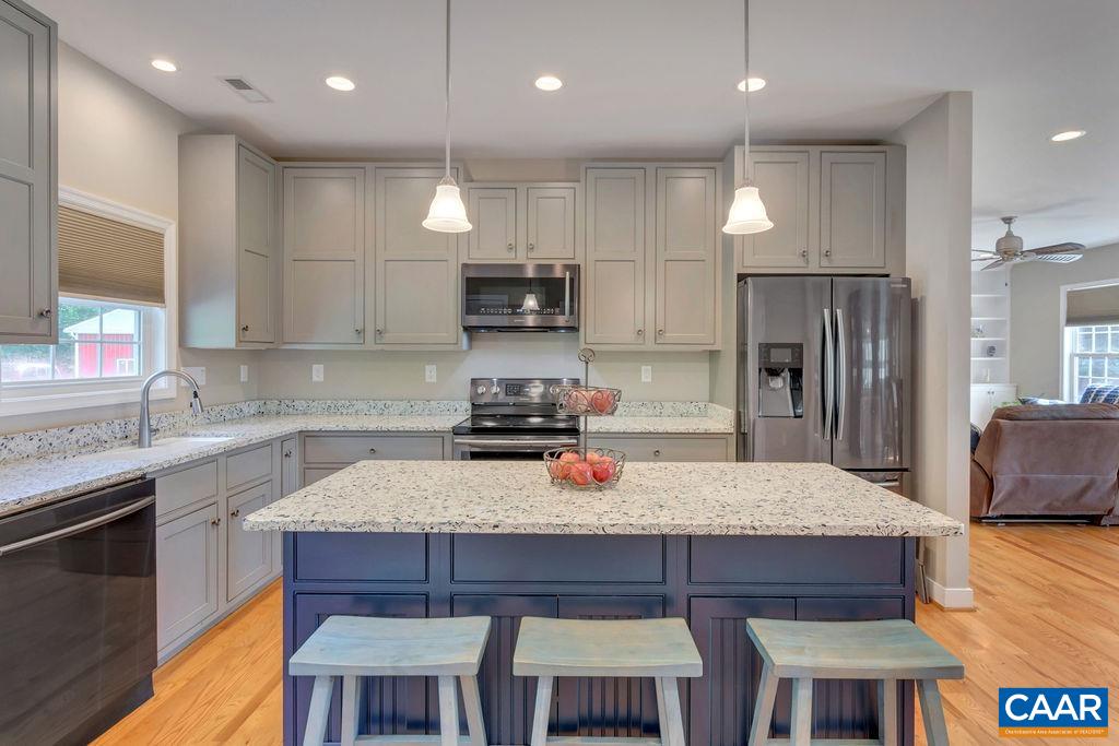 1275 Poplar Spring Road Scottsville, VA 24590 - Photo 2 of 51 a kitchen with kitchen island granite countertop wooden cabinets and stainless steel appliances