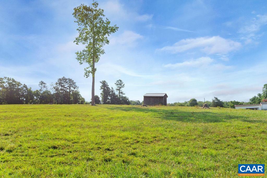 1275 Poplar Spring Road Scottsville, VA 24590 - Photo 38 of 51 a view of a big yard with an outdoor space and seating
