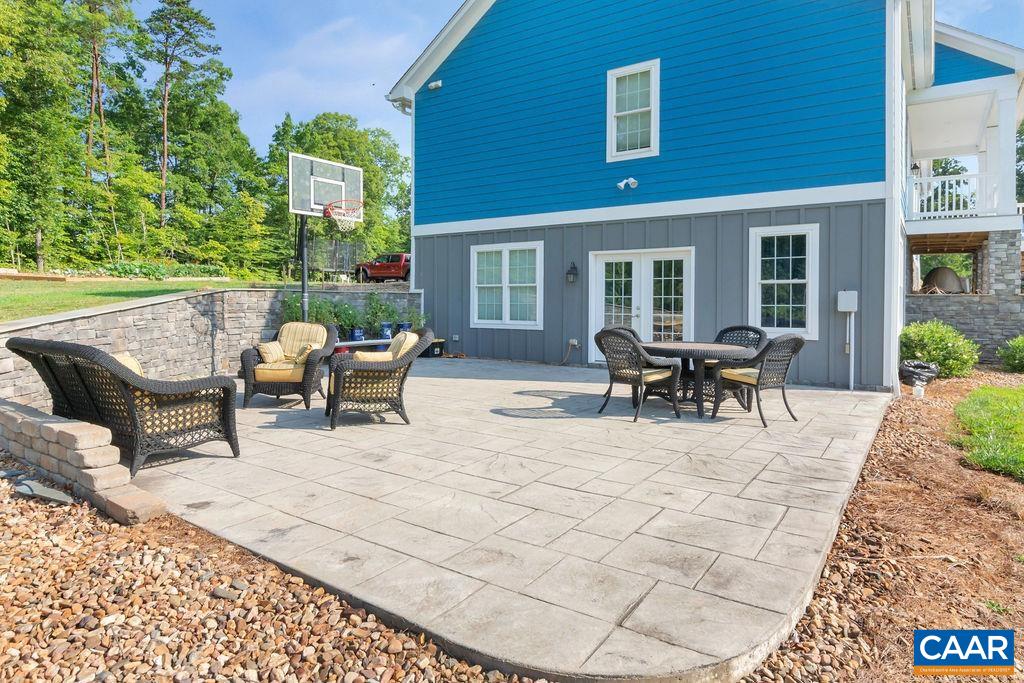1275 Poplar Spring Road Scottsville, VA 24590 - Photo 40 of 51 a view of a patio with dining table and chairs with wooden floor and fence
