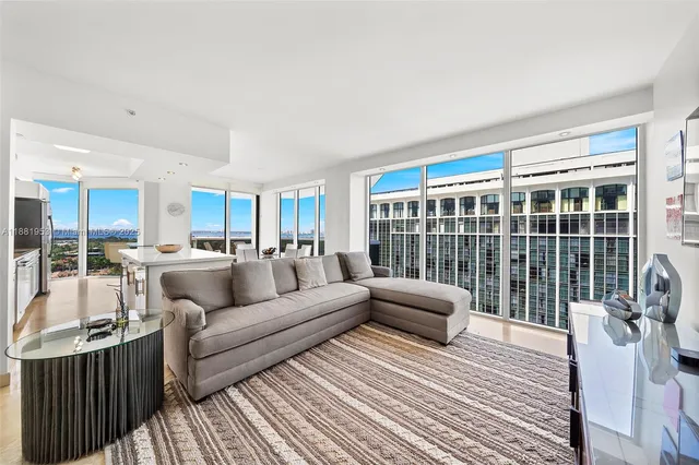 a living room with furniture and a large window
