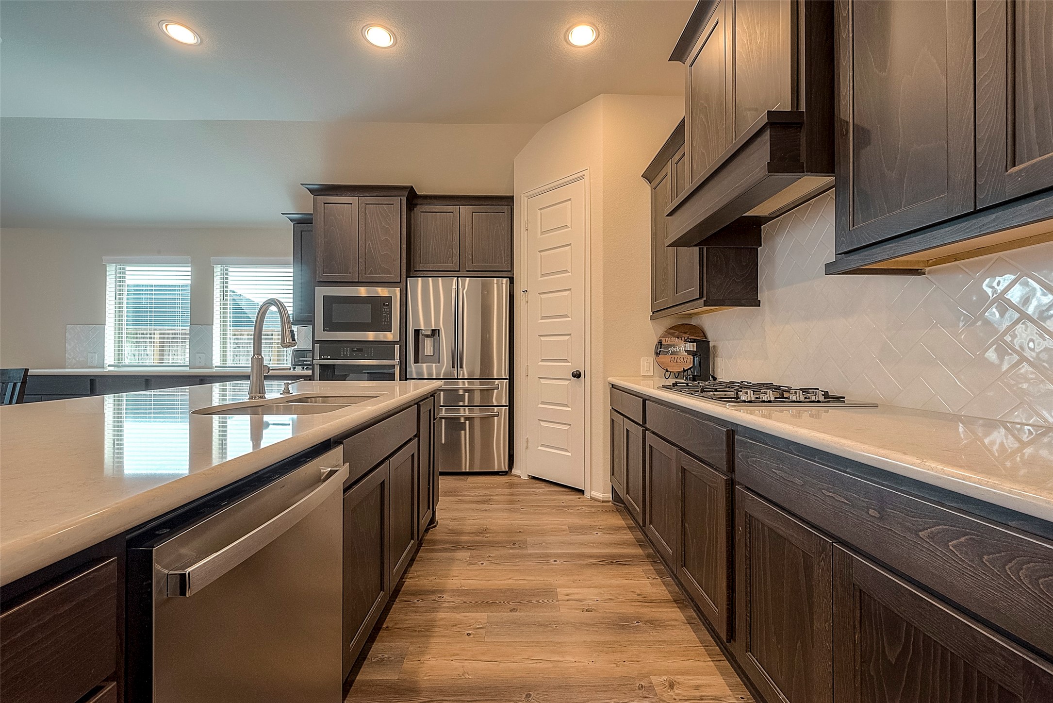 4602 Ana Ridge Lane Fulshear, TX 77441 - Photo 12 of 42 a large kitchen with stainless steel appliances granite countertop a lot of counter space and a sink