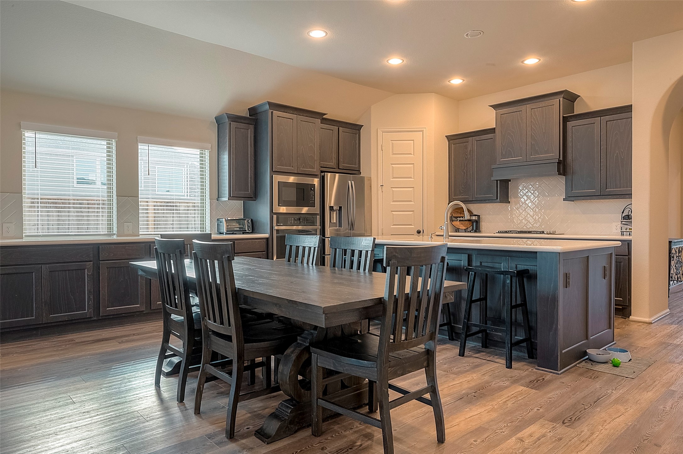 4602 Ana Ridge Lane Fulshear, TX 77441 - Photo 17 of 42 a dining room with furniture a window and wooden floor