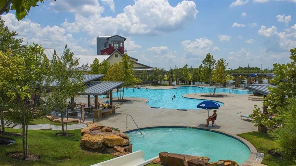 4602 Ana Ridge Lane Fulshear, TX 77441 - Photo 41 of 42 an aerial view of a house with garden space and lake view