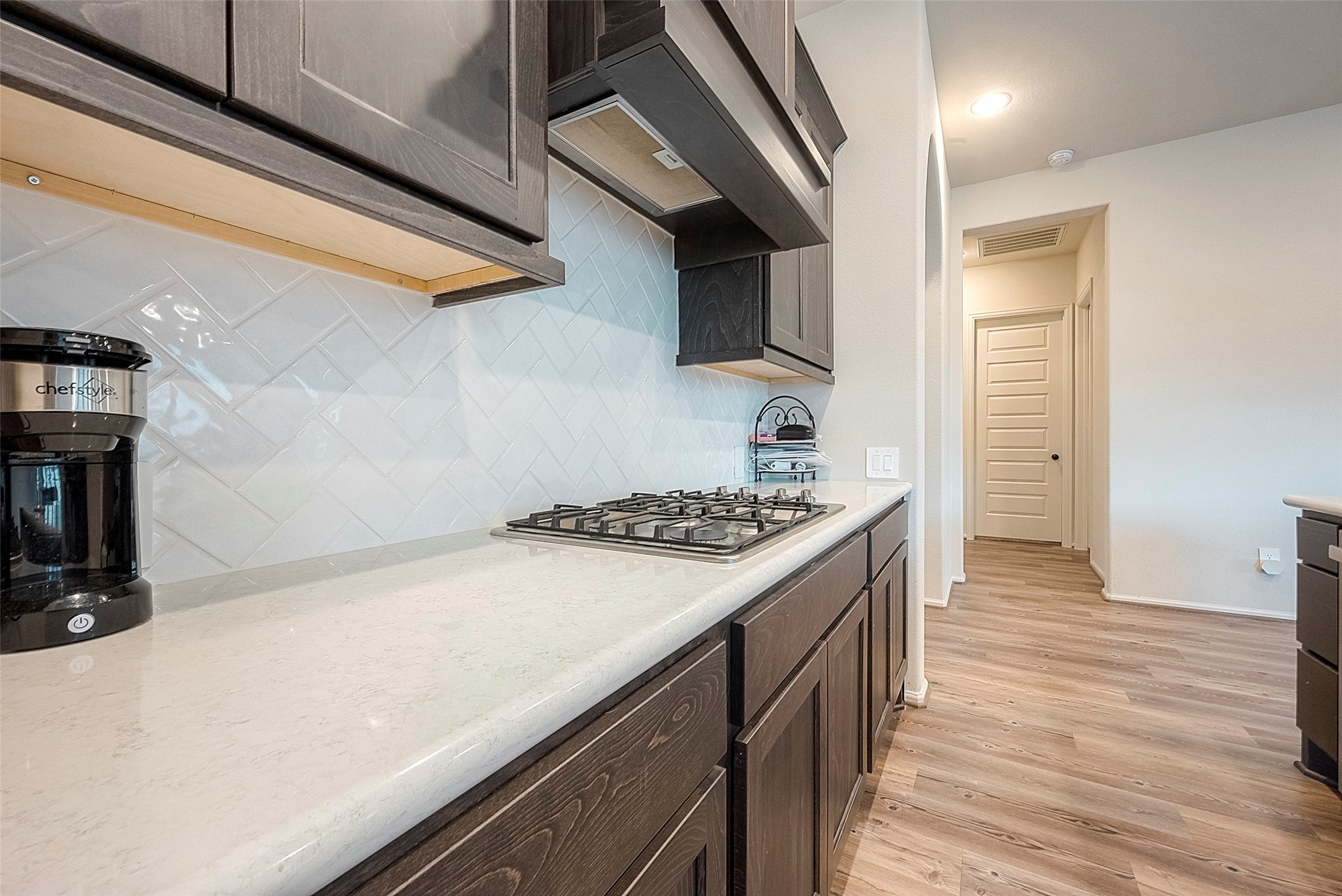 4602 Ana Ridge Lane Fulshear, TX 77441 - Photo 7 of 42 a kitchen with a stove and a refrigerator