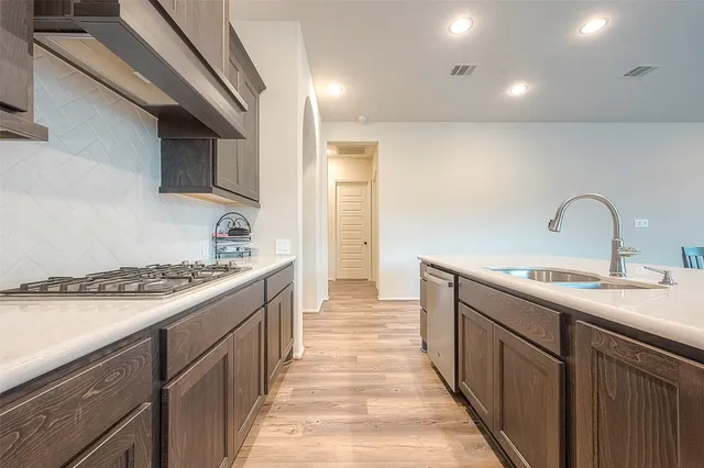a kitchen with sink and stove