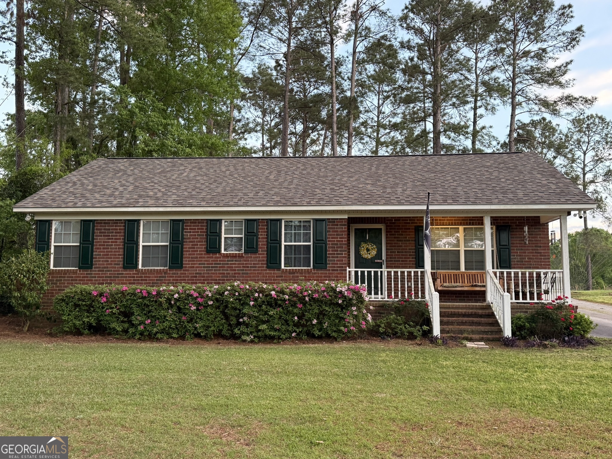 a front view of a house with a garden