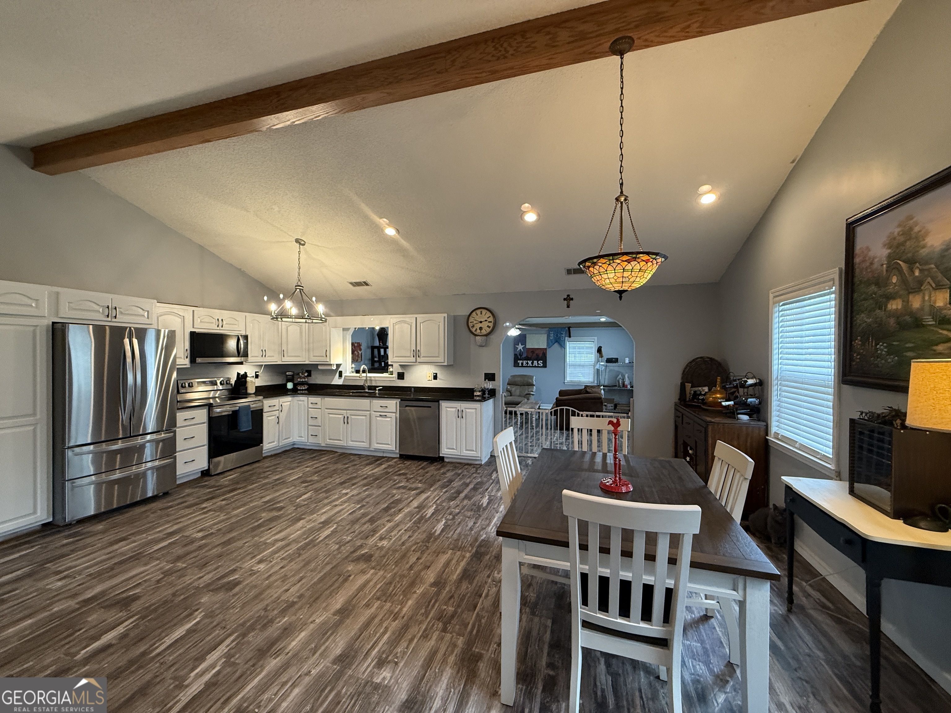 26844 Highway 46 Metter, GA 30439 - Photo 11 of 36 a kitchen with stainless steel appliances kitchen island granite countertop a refrigerator a stove a sink dishwasher and a dining table with wooden floor
