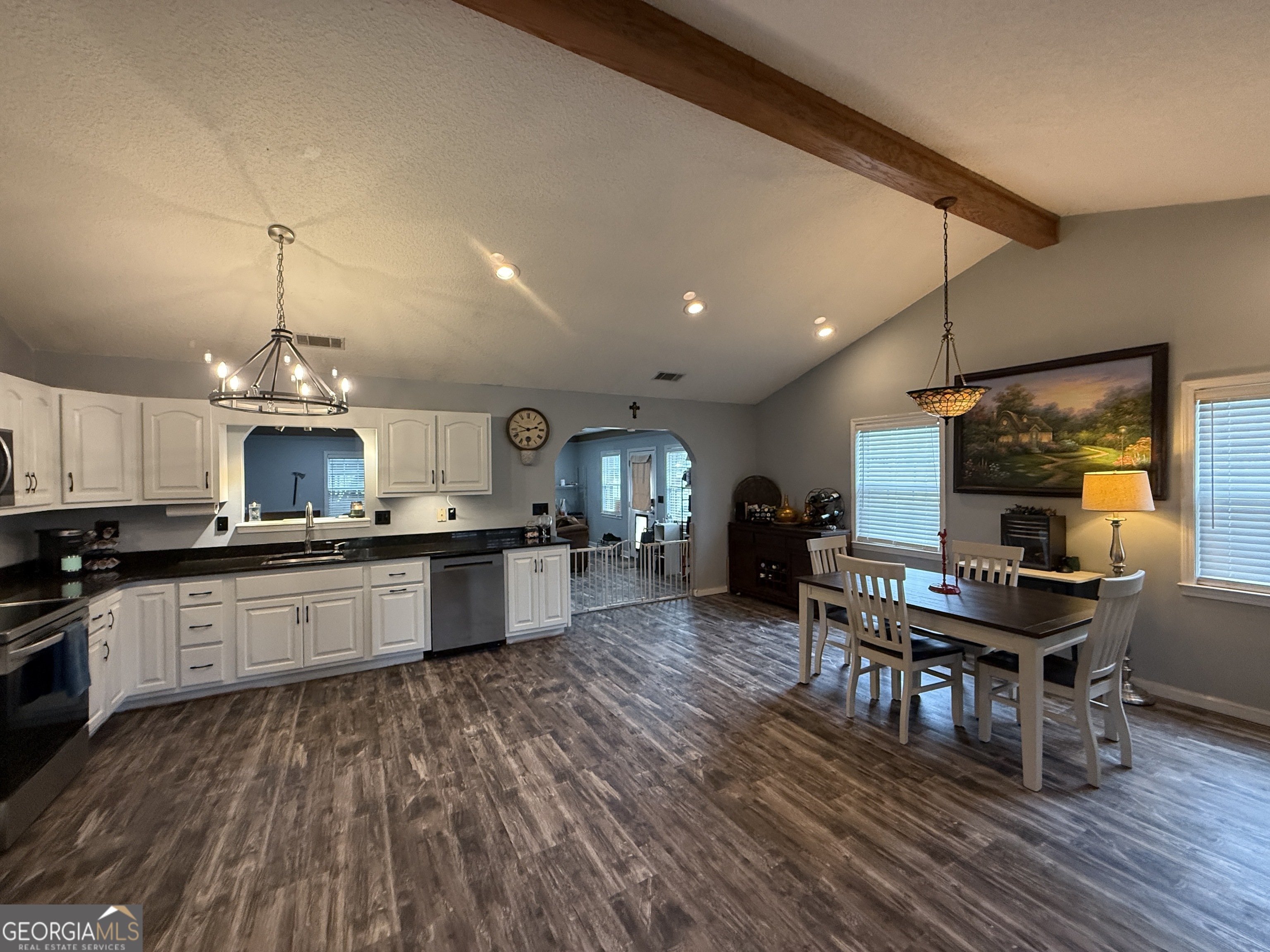 26844 Highway 46 Metter, GA 30439 - Photo 13 of 36 a kitchen with stainless steel appliances granite countertop a stove top oven a sink dishwasher a dining table and chairs with wooden floor