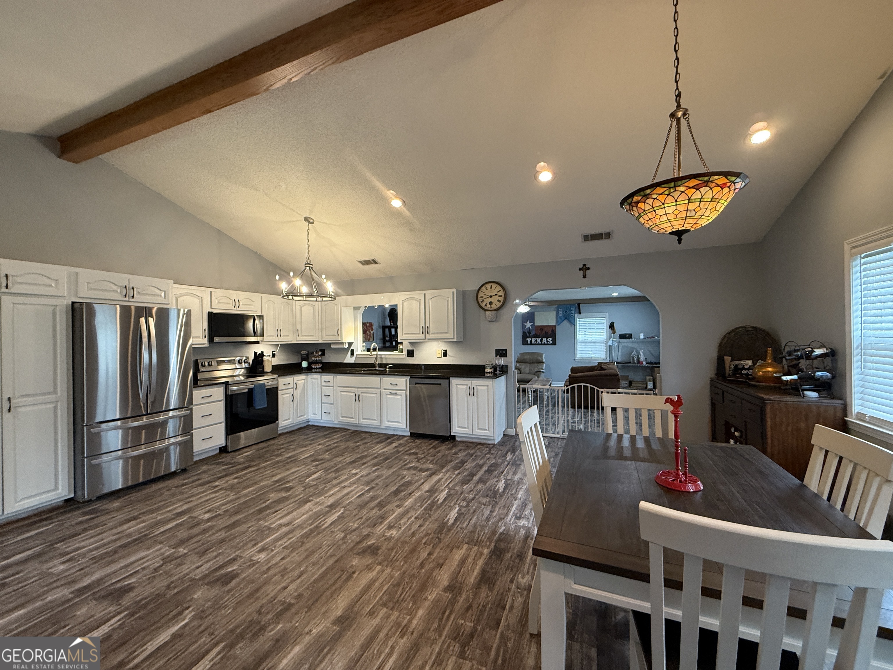 26844 Highway 46 Metter, GA 30439 - Photo 15 of 36 a kitchen with stainless steel appliances kitchen island granite countertop a refrigerator a stove top oven a sink dishwasher and white cabinets with wooden floor