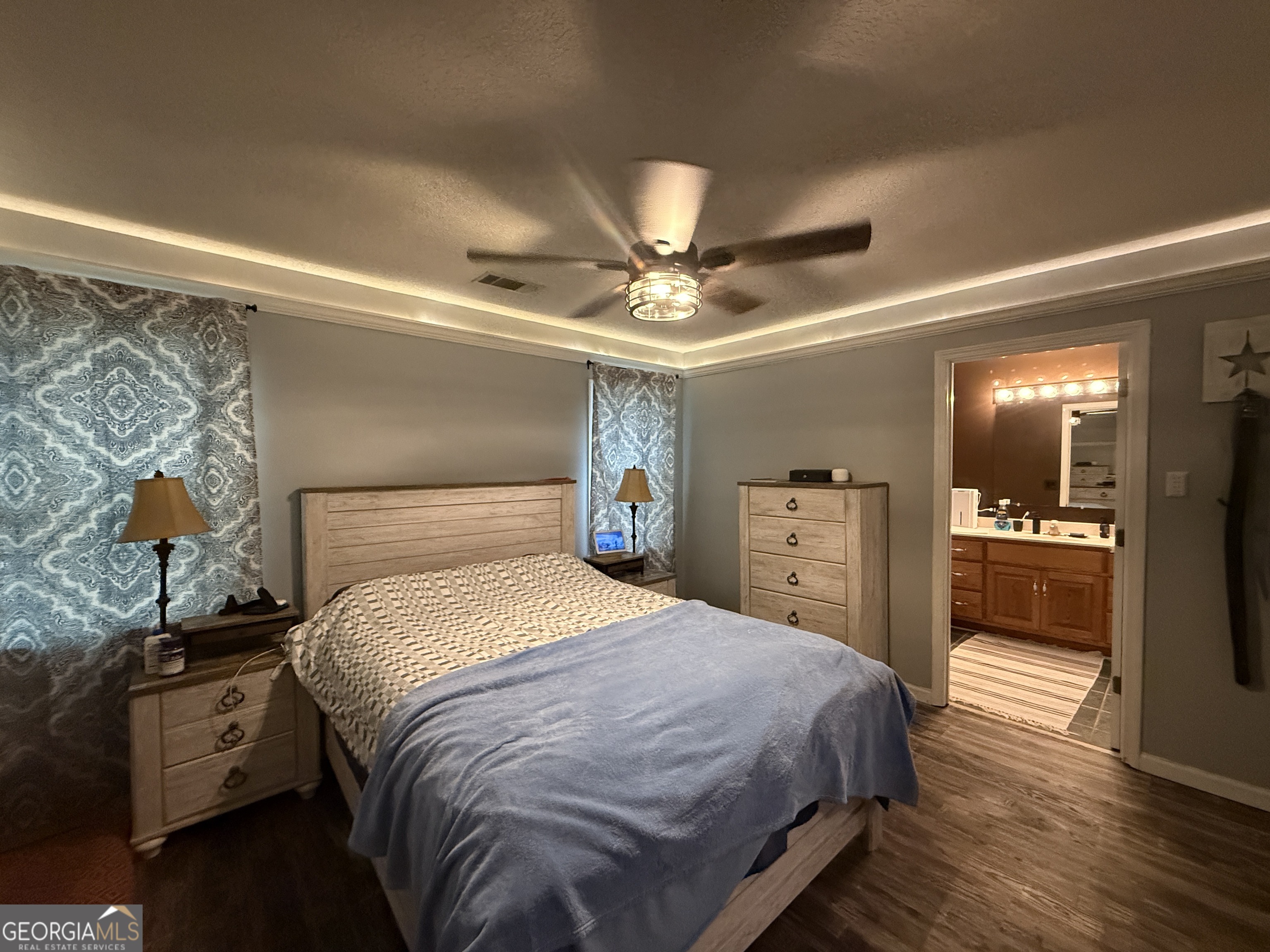 26844 Highway 46 Metter, GA 30439 - Photo 28 of 36 a bedroom with a bed and a chandelier