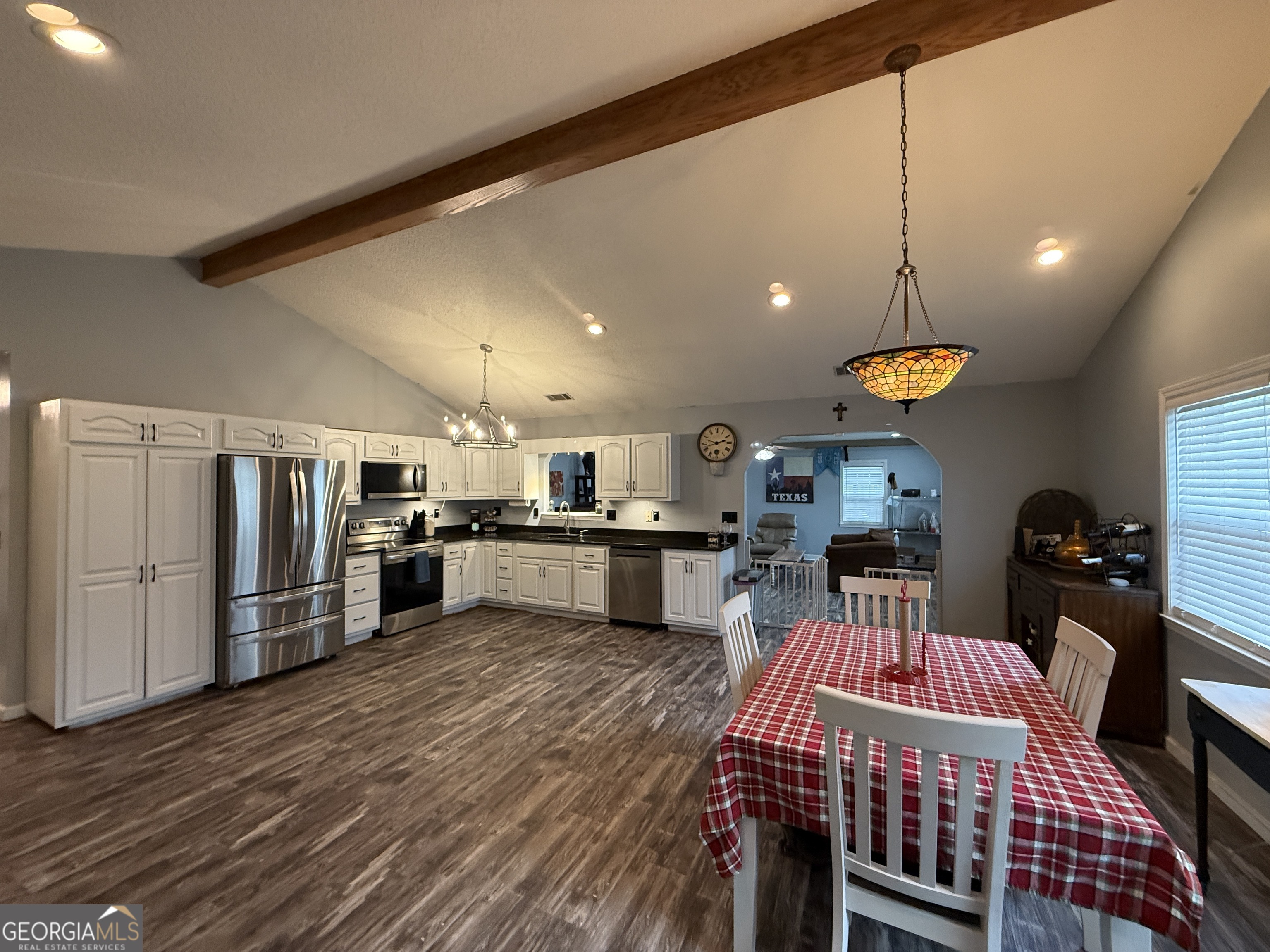 26844 Highway 46 Metter, GA 30439 - Photo 7 of 36 a kitchen with stainless steel appliances kitchen island granite countertop a refrigerator a oven a sink a dining table and chairs with wooden floor