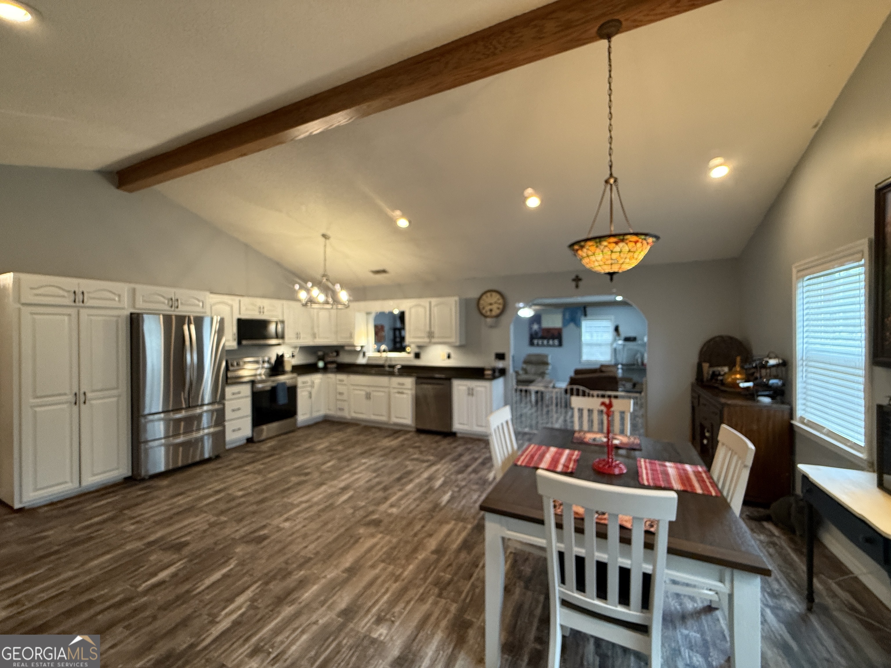 26844 Highway 46 Metter, GA 30439 - Photo 8 of 36 a living room with stainless steel appliances kitchen island granite countertop a table chairs and a refrigerator