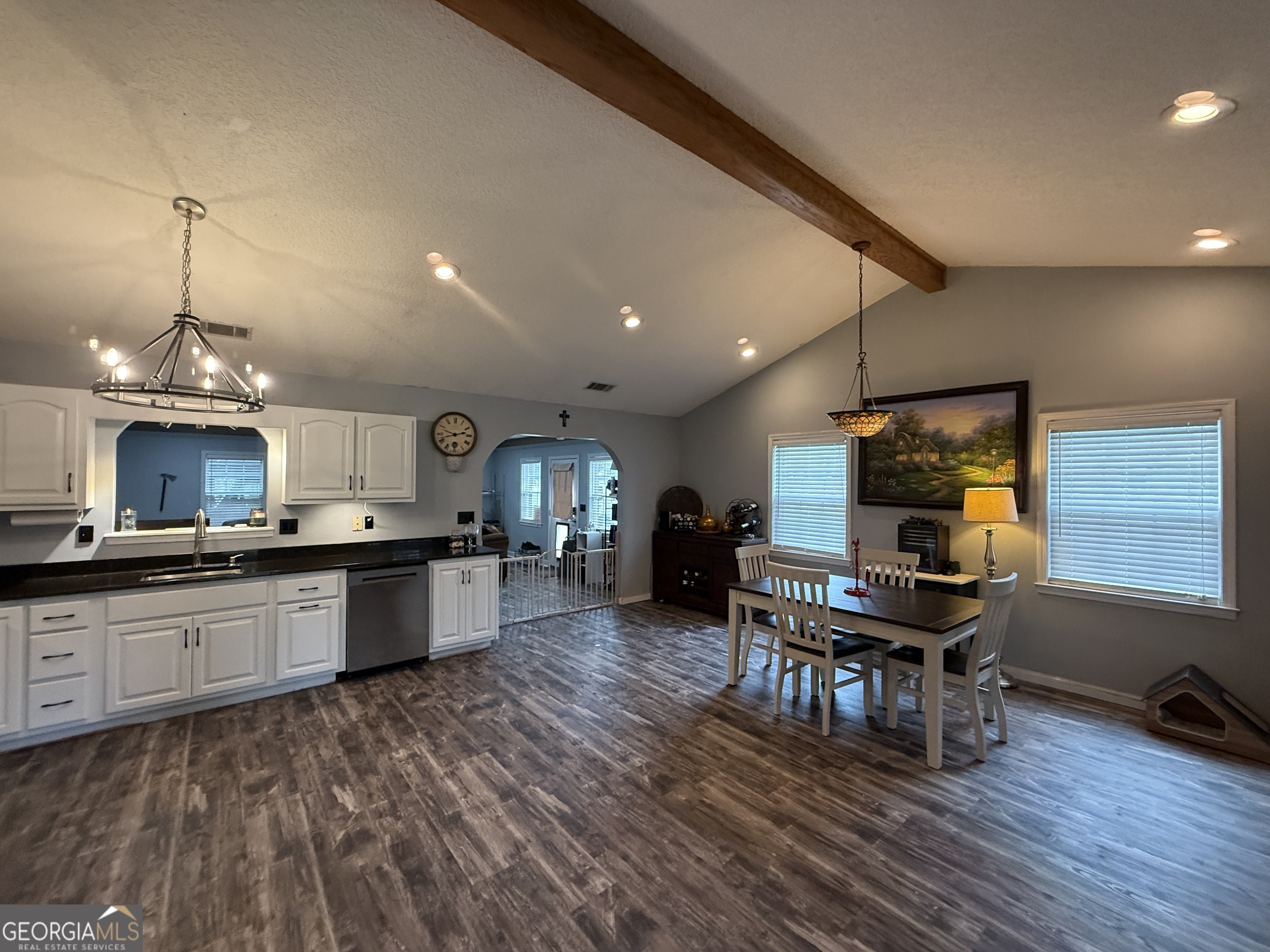 26844 Highway 46 Metter, GA 30439 - Photo 9 of 36 a kitchen with stainless steel appliances granite countertop a sink dishwasher a microwave oven a dining table and chairs with wooden floor