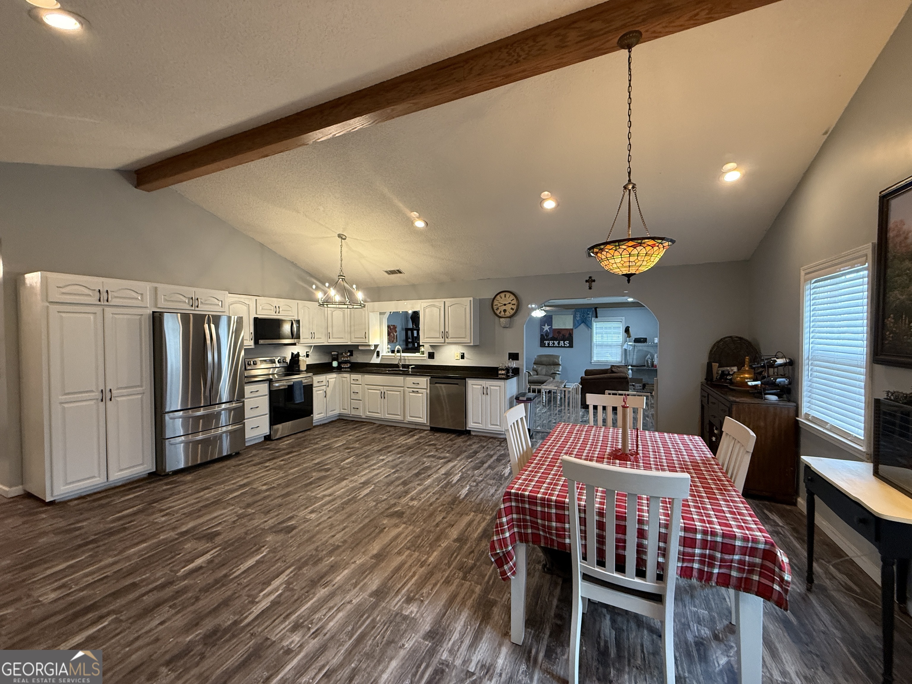 26844 Highway 46 Metter, GA 30439 - Photo 10 of 36 a kitchen with stainless steel appliances kitchen island granite countertop a refrigerator a stove a microwave oven a dining table and chairs with wooden floor