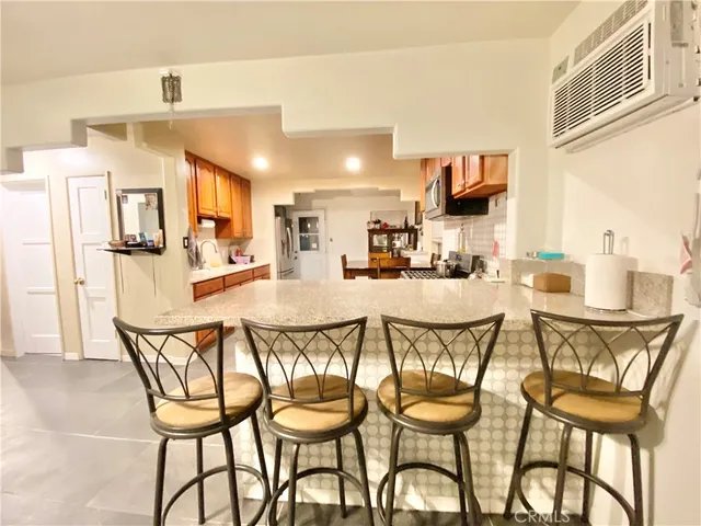 a dining space with furniture and view kitchen